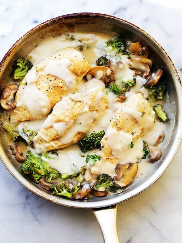 Creamy chicken Alfredo with broccoli in a skillet.