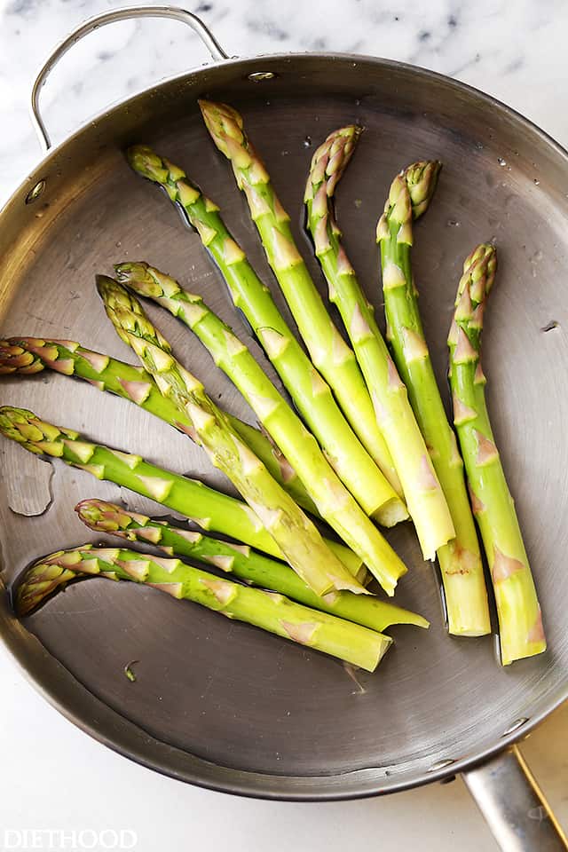 Steaming Asparagus in a pan.