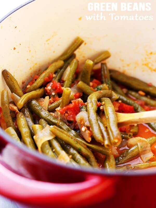 Green Beans and Tomatoes Recipe – Slow cooked green beans with tomatoes, onions and garlic. This easy, yet incredibly flavorful recipe makes for a perfect side dish to any main course.