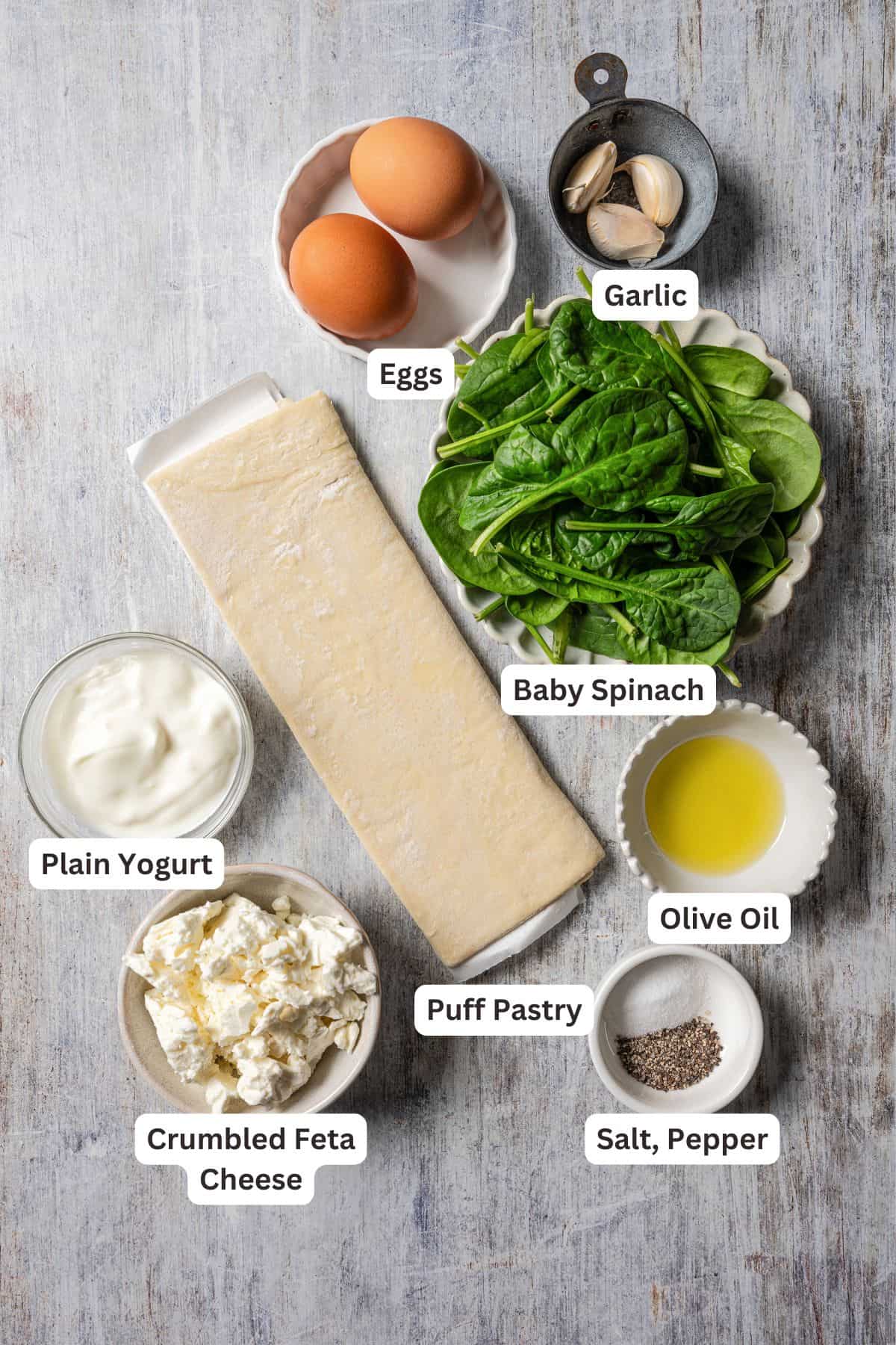 Spinach and feta puff pastry ingredients with text labels overlaying each ingredient.