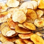 Homemade baked potato chips cooling on a wire rack.