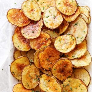 Homemade potato chips are served in a basket.