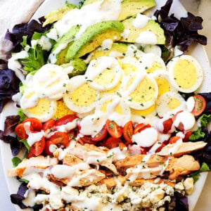 Cobb Salad Recipe - This classic American main-dish salad is packed with chicken, avocado, sweet tomatoes, crunchy bacon, blue cheese, and eggs, all topped with a lightened-up blue cheese dressing.