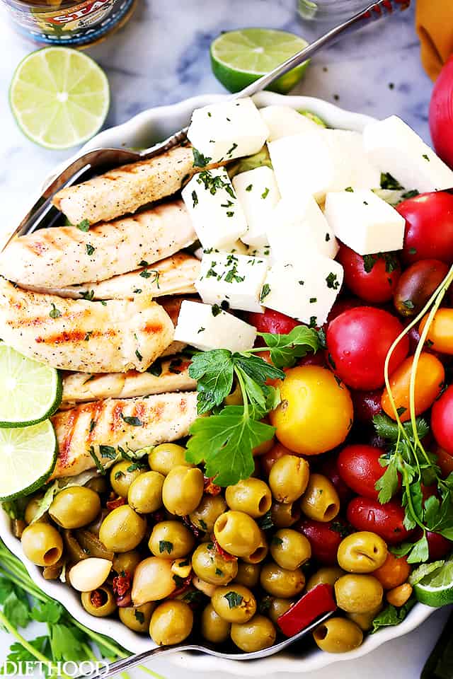Lime Cumin Chicken Salad with Tomatoes, Olives and Queso Fresco - A huge bowl of flavor-packed, colorful, healthy chicken salad with tomatoes, fiesta blend olives and Mexican cheese.