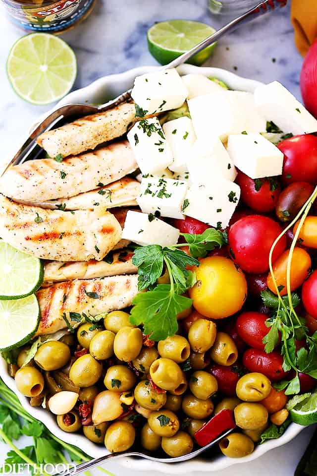 Lime Cumin Chicken Salad with Tomatoes, Olives and Queso Fresco - A huge bowl of flavor-packed, colorful chicken salad with tomatoes, fiesta blend olives and Mexican cheese.