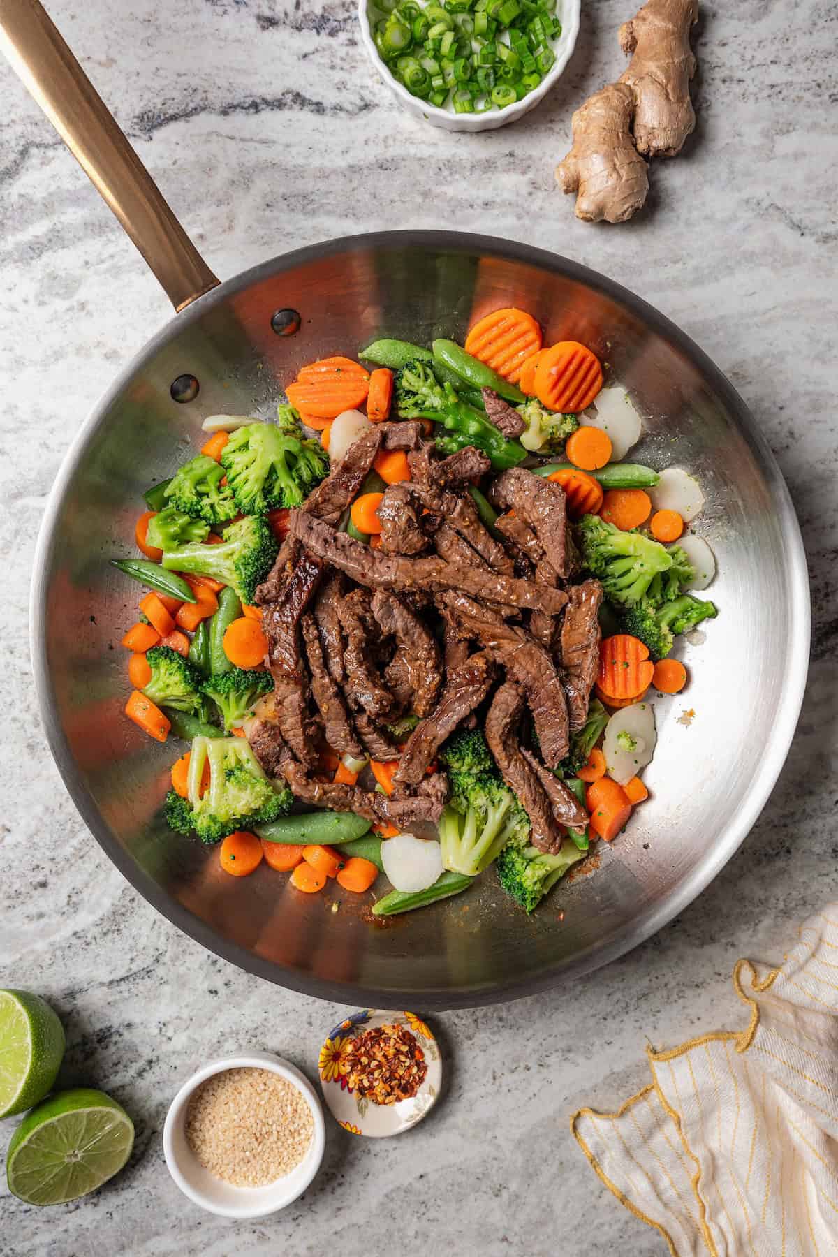 Beef strips added back to the pan with stir fried vegetables.