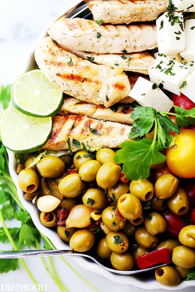 Lime Cumin Chicken Salad with Tomatoes, Olives and Queso Fresco - A huge bowl of flavor-packed, colorful chicken salad with tomatoes, fiesta blend olives and Mexican cheese.