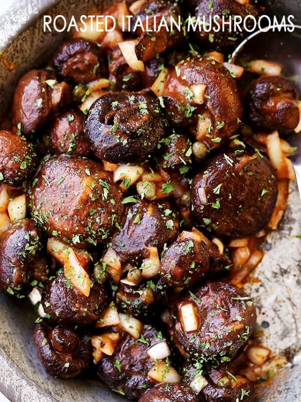 Italian mushrooms tossed with tomato sauce, onions, capers, and lemon zest in a metal bowl.