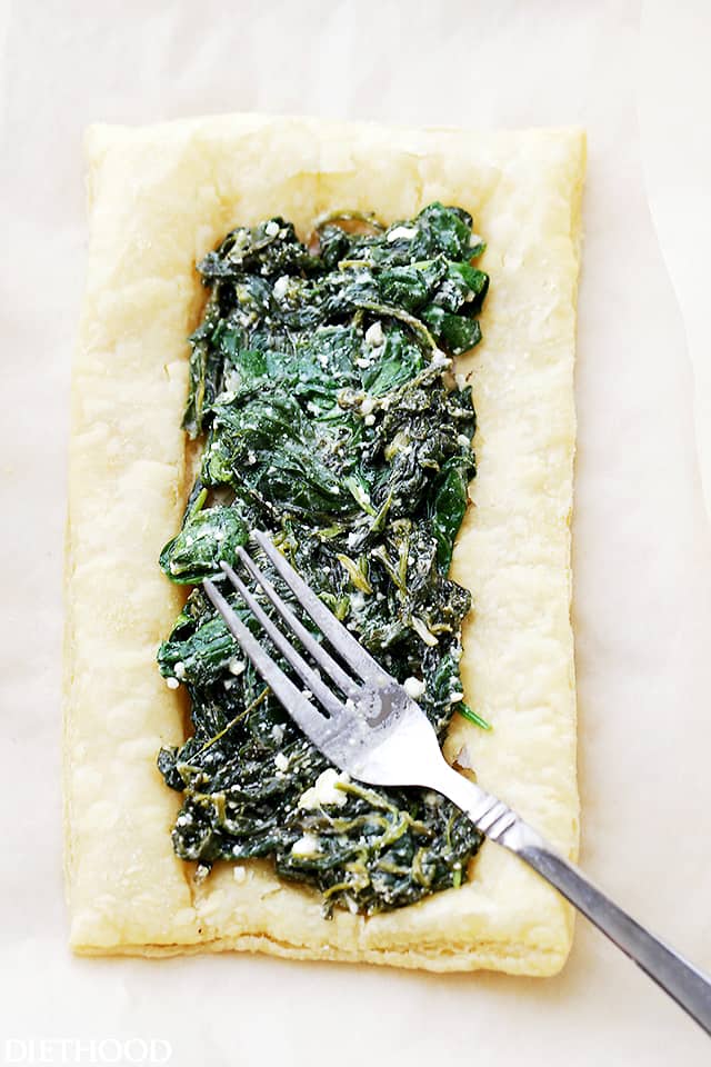 Spinach and Feta Puff Pastry Breakfast Tart Recipe - In just a few minutes of prep time, you can have this ridiculously easy, yet incredibly flavorful golden puff pastry topped with spinach, feta, and eggs. Perfect for breakfast, brunch, or even as an appetizer.