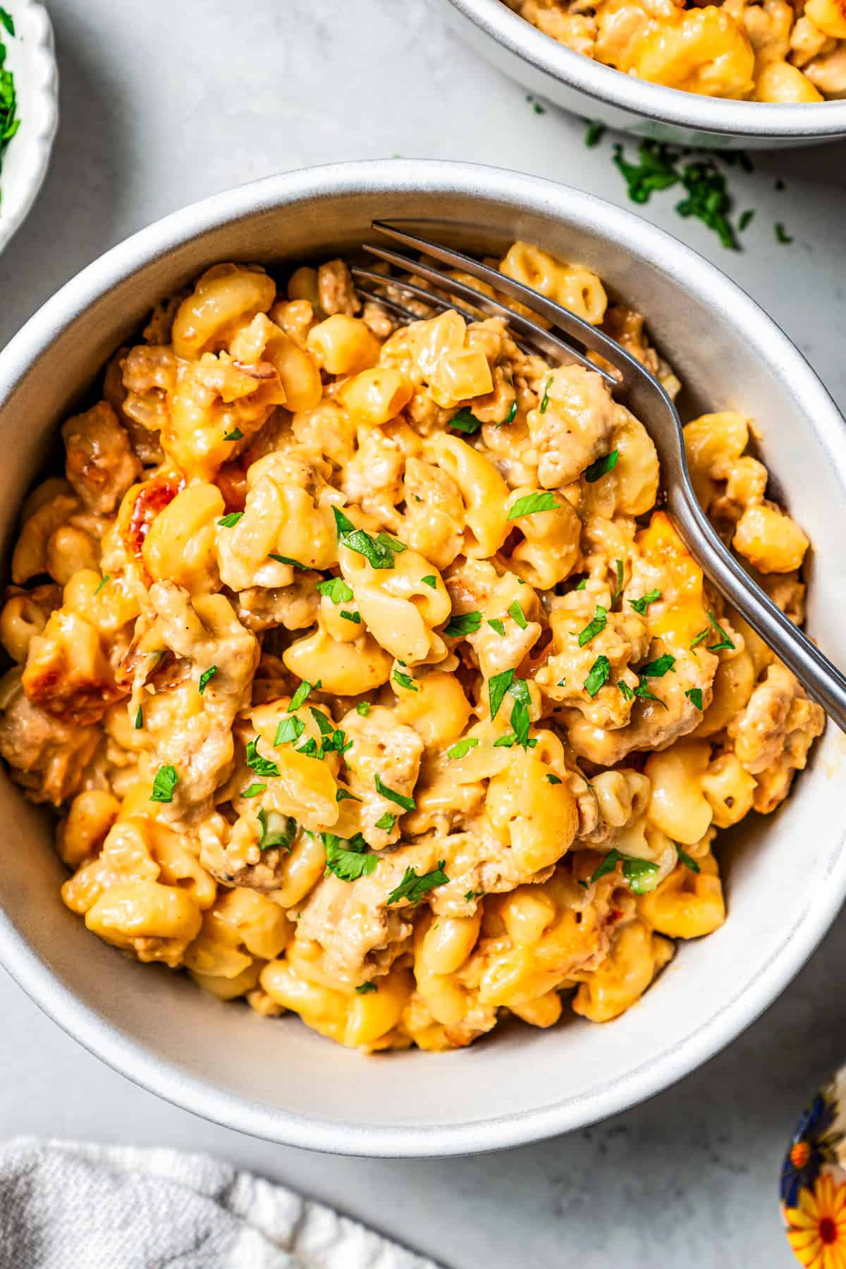 Overhead image of macaroni and ground beef in a bowl with a fork.