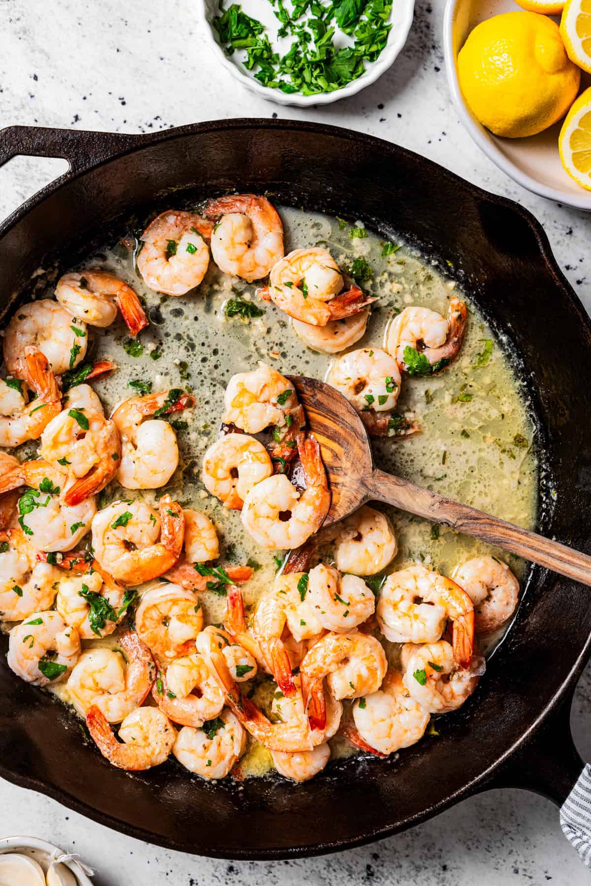 Sauteeing shrimp in a cast iron skillet.