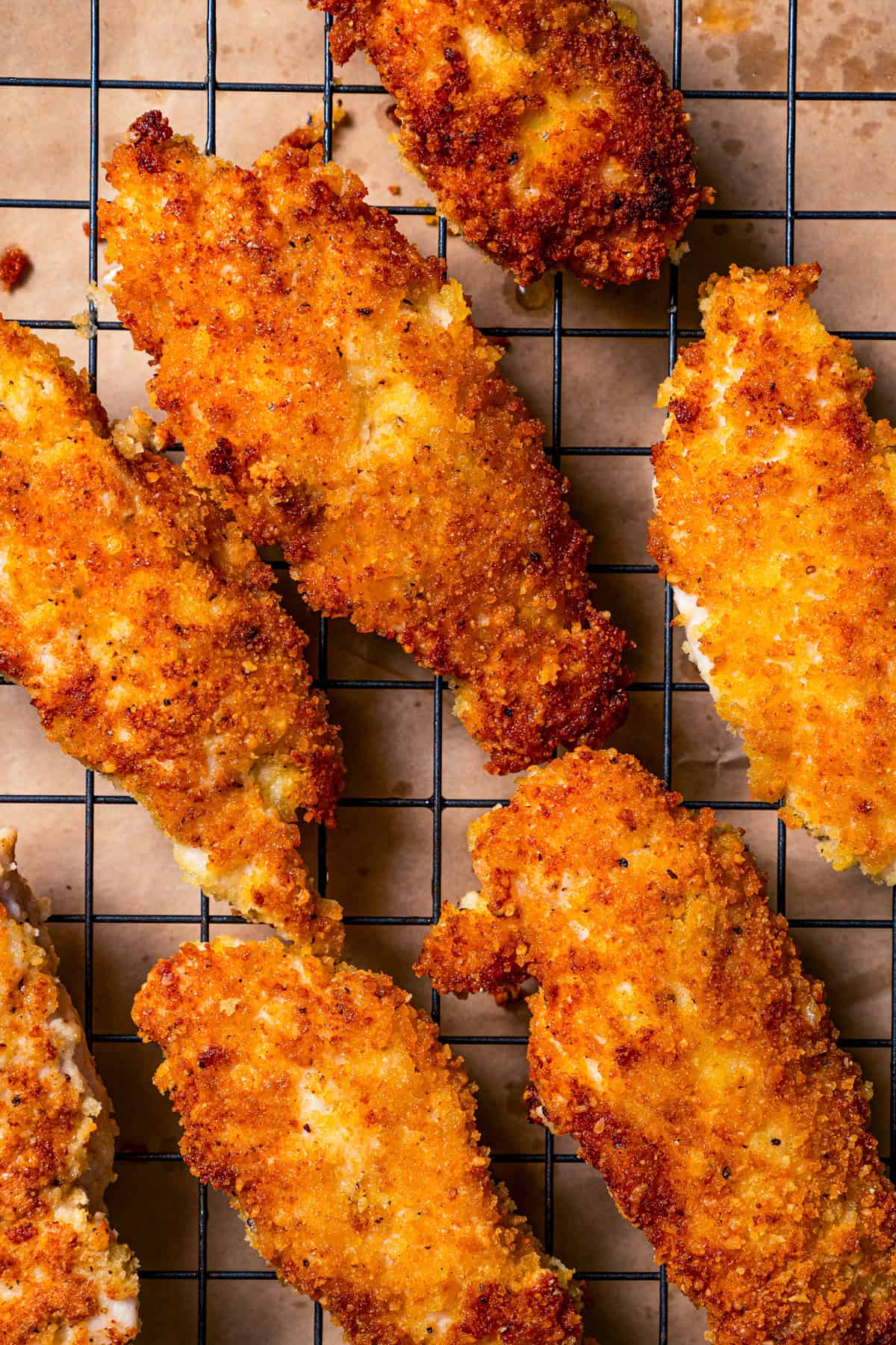 Parmesan chicken tenders on a wire rack.