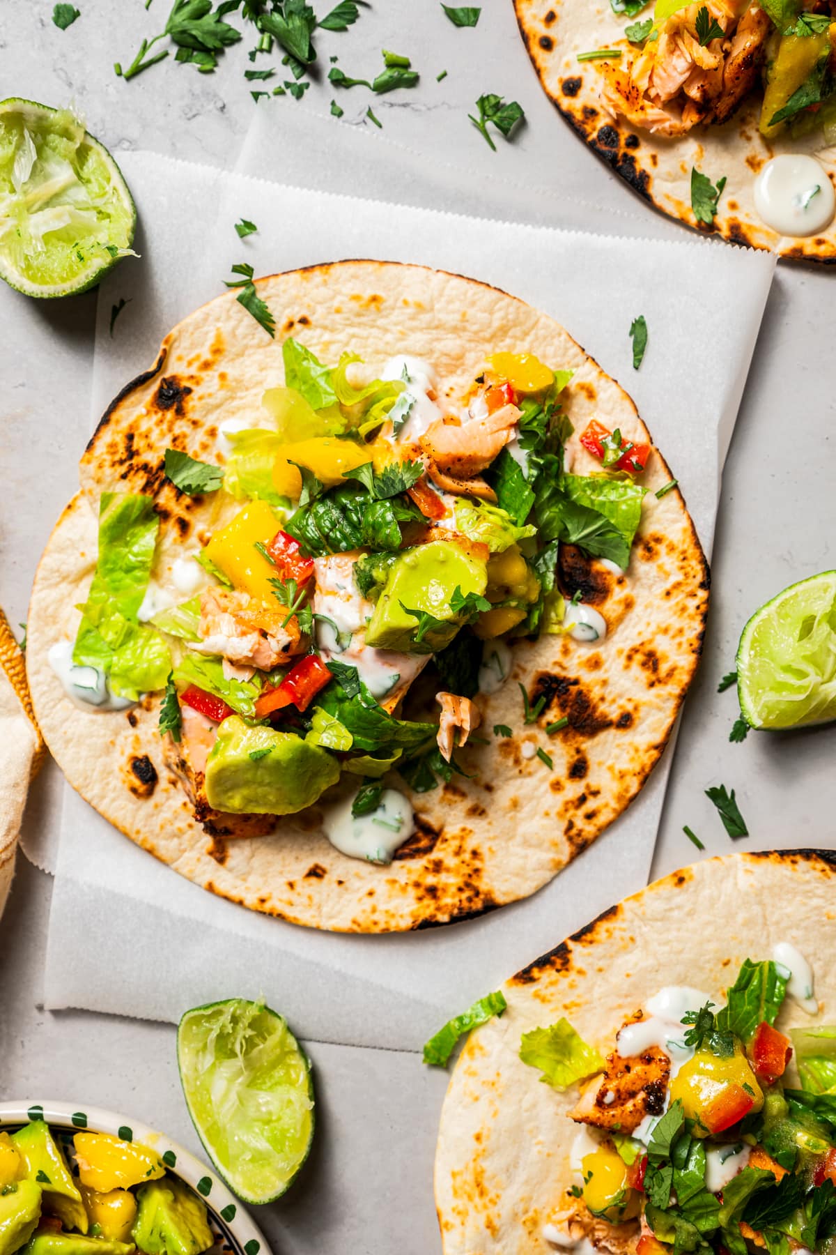 Overhead of salmon tacos with mango avocado salsa.