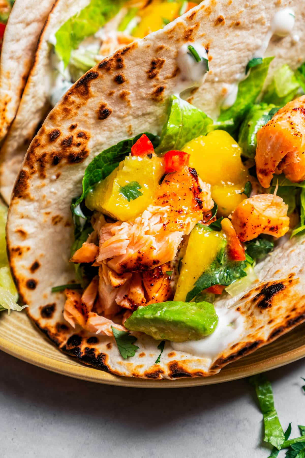 Closeup of salmon tacos with mango avocado salsa.