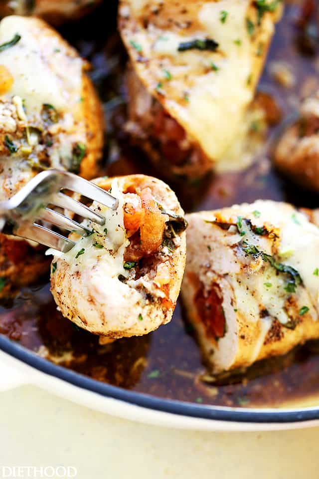 Bruschetta Stuffed Balsamic Chicken - This is the juiciest chicken you will ever have! Baked in a delicious balsamic mixture and stuffed with fresh tomatoes, basil, and mozzarella, this chicken recipe is just finger-licking GOOD!