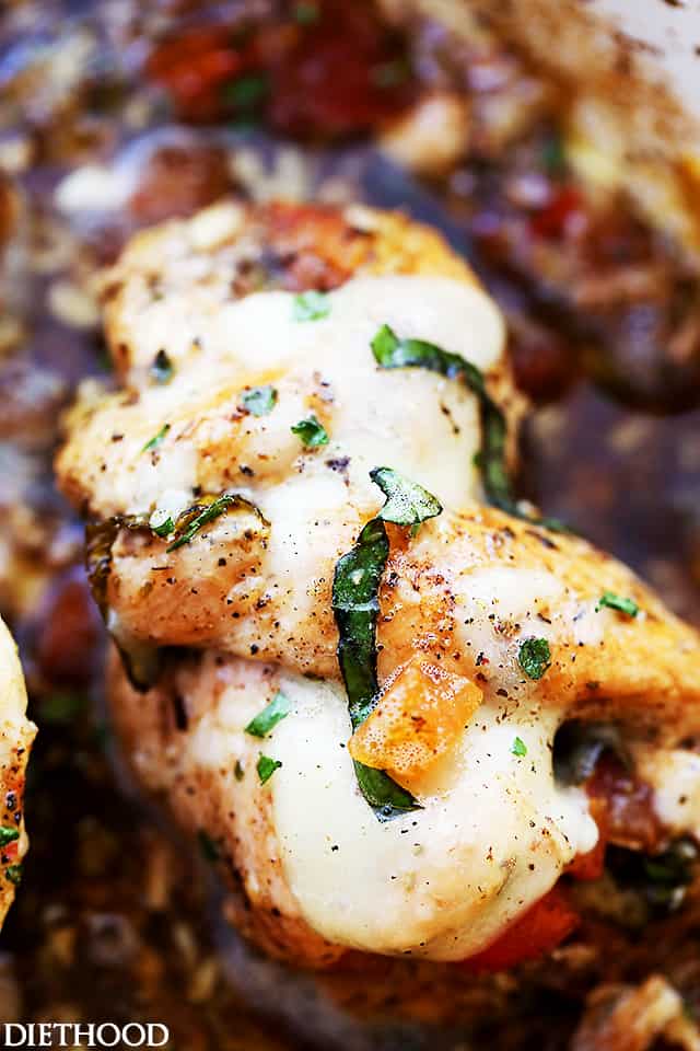 Bruschetta Stuffed Balsamic Chicken - This is the juiciest chicken you will ever have! Baked in a delicious balsamic mixture and stuffed with fresh tomatoes, basil, and mozzarella, this chicken recipe is just finger-licking GOOD!