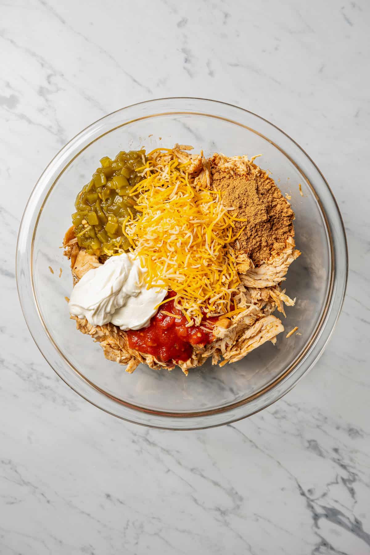 Flautas filling ingredients combined in a glass bowl.