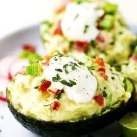 Deviled Avocados - For a twist on traditional deviled eggs, these avocados are filled with a mixture of eggs, bacon, feta cheese, green onions, avocados, and a cool delicious helping of yogurt that brings it all together.