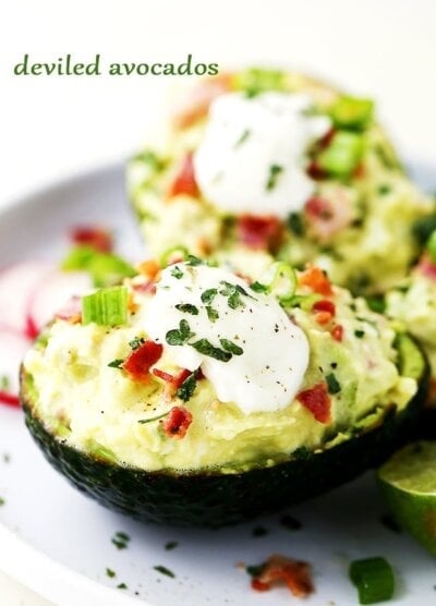 Deviled Avocados - For a twist on traditional deviled eggs, these avocados are filled with a mixture of eggs, bacon, feta cheese, green onions, avocados, and a cool delicious helping of yogurt that brings it all together.