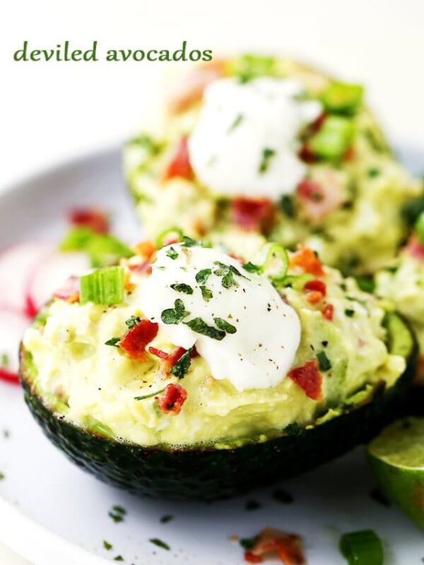 Deviled Avocados - For a twist on traditional deviled eggs, these avocados are filled with a mixture of eggs, bacon, feta cheese, green onions, avocados, and a cool delicious helping of yogurt that brings it all together.