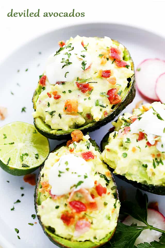 Deviled Avocados arranged on a white plate.