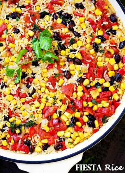Fiesta Rice Recipe - Mexican inspired side dish recipe with fluffy, tender, flavorful rice and colorful veggies. Serve with Mexican food like, tacos or enchiladas, but it's just as good served with steak or chicken.