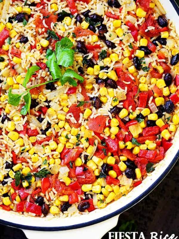 Fiesta Rice Recipe - Mexican inspired side dish recipe with fluffy, tender, flavorful rice and colorful veggies. Serve with Mexican food like, tacos or enchiladas, but it's just as good served with steak or chicken.