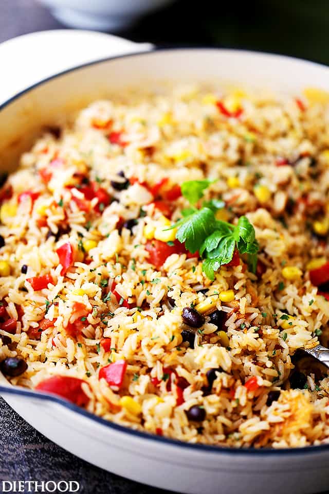 Fiesta Rice Recipe - Mexican inspired side dish recipe with fluffy, tender, flavorful rice and colorful veggies. Serve with Mexican food like, tacos or enchiladas, but it's just as good served with steak or chicken.