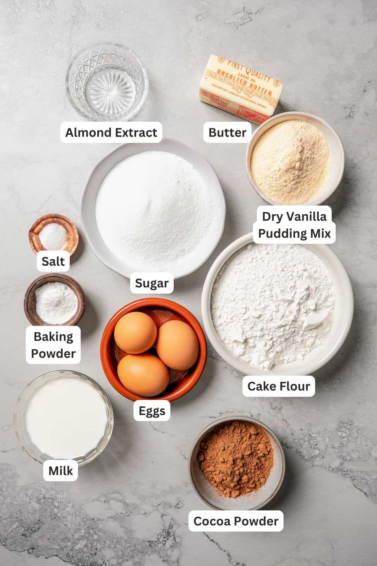 German marble cake ingredients with text labels overlaying each ingredient.