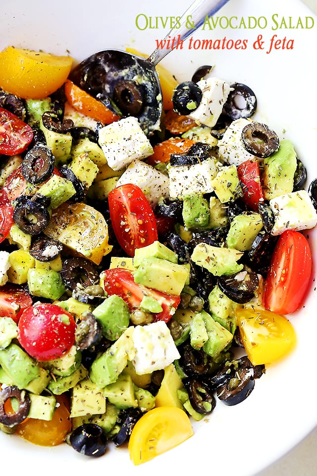 Olives and Avocado Salad with Tomatoes and Feta Cheese served in a white salad bowl.