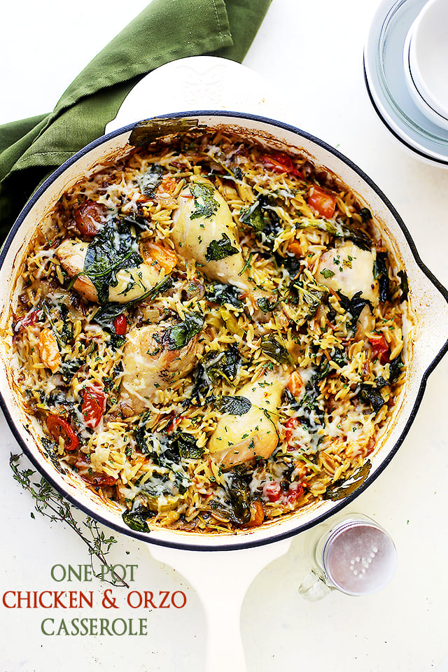 Overhead image of a skillet filled with orzo pasta and chicken drumsticks.