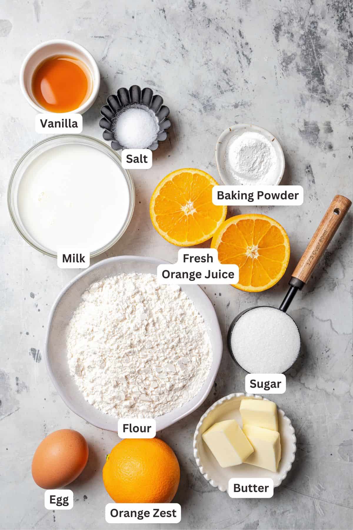 Orange scone ingredients with text labels overlaying each ingredient.