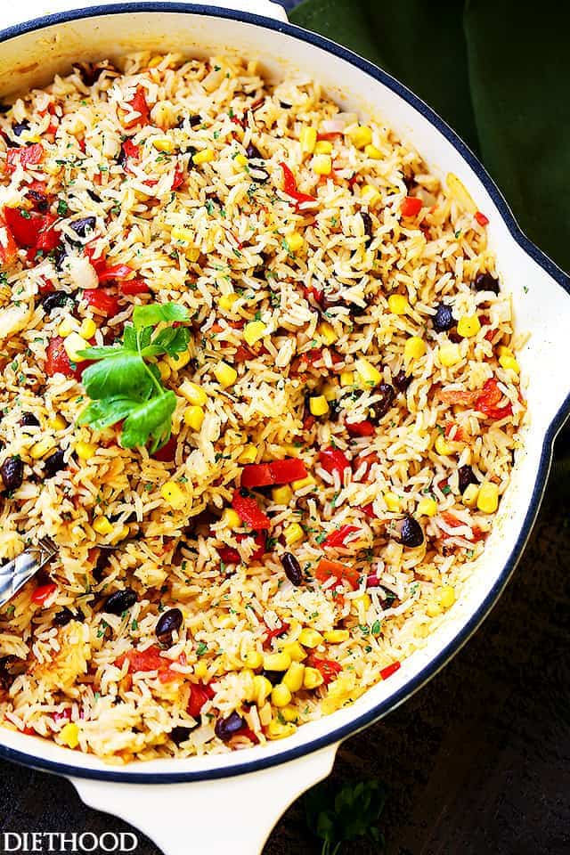 Fiesta Rice Recipe - Mexican inspired side dish recipe with fluffy, tender, flavorful rice and colorful veggies. Serve with Mexican food like, tacos or enchiladas, but it's just as good served with steak or chicken.