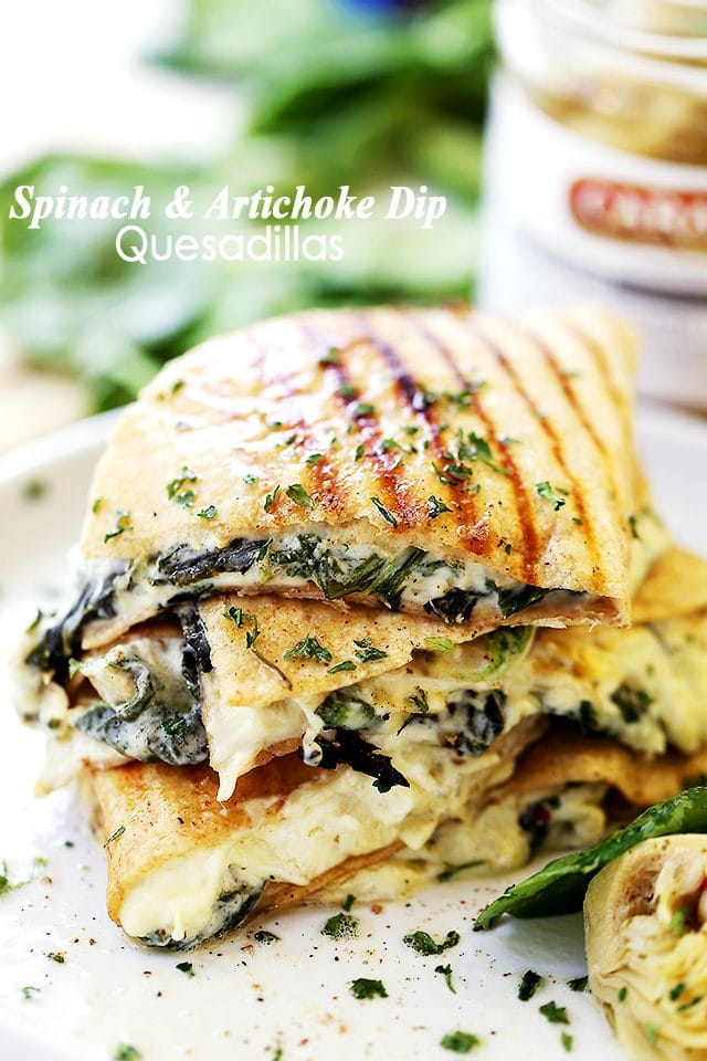 Stacked Spinach and Artichoke Dip Quesadillas on a white plate.