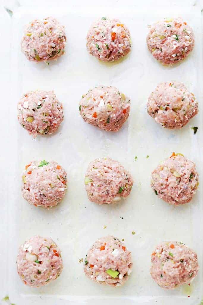 Shaped turkey meatballs on a white backdrop.