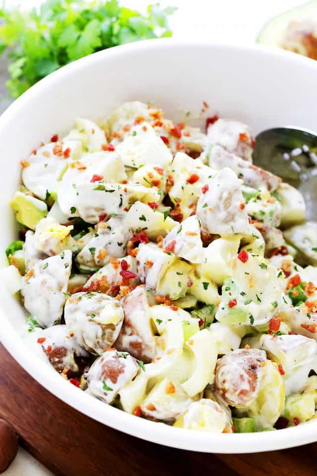 Lightened-Up Creamy Potato Salad Recipe - Whip up this lightened-up creamy potato salad packed with eggs, avocado and turkey bacon for your next summer picnic or barbecue!