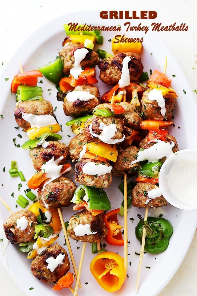 Grilled Mediterranean Turkey Meatballs Skewers arranged on a white plate and sprinkled with parsley