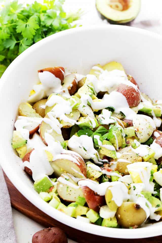 Lightened-Up Creamy Potato Salad in a white salad bowl.