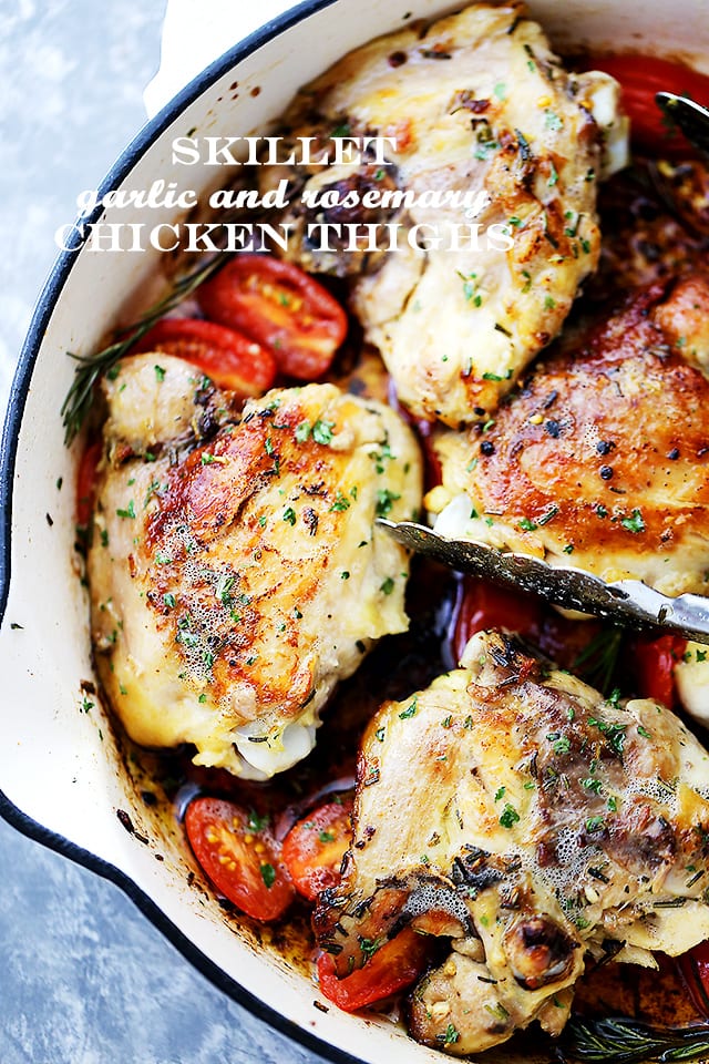 Rosemary and garlic chicken thighs in a skillet.