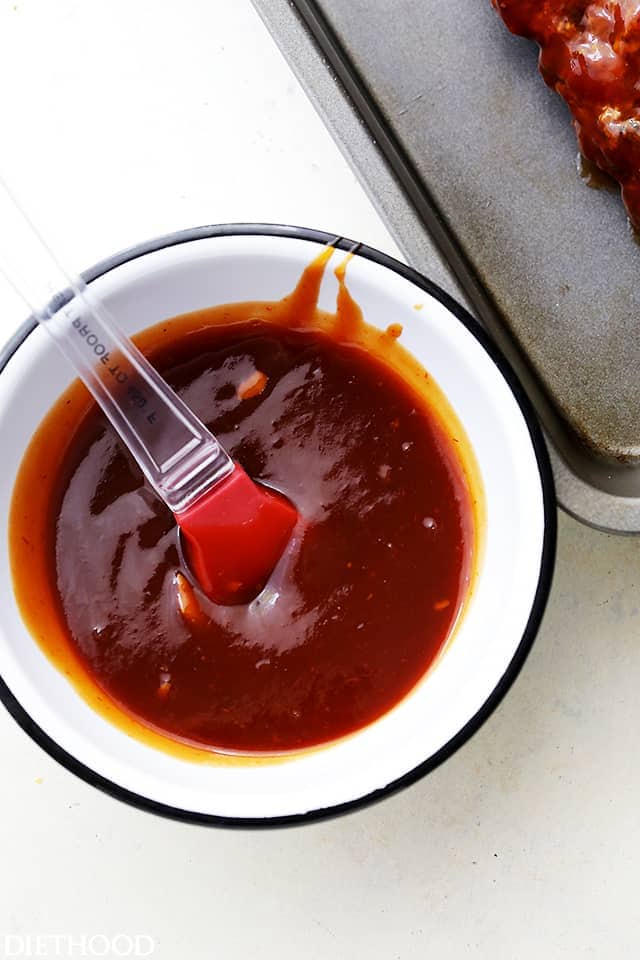 A Bowl of Homemade Honey Barbecue Sauce Beside a Metal Baking Sheet