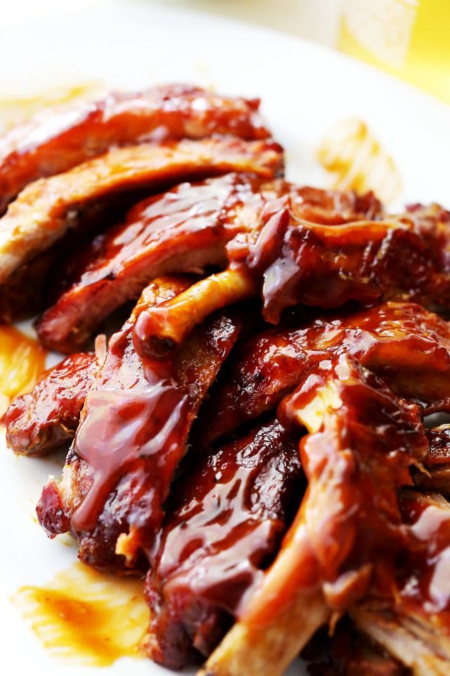 A Close-Up Shot of Freshly Made Barbecue Ribs Piled Up on a White Plate