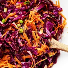 Red Cabbage and Carrot Slaw Recipe - Tossed with an incredible Apple Cider Vinaigrette, this tangy slaw is light, crunchy, refreshing, and serves perfectly as a side dish or even an appetizer.