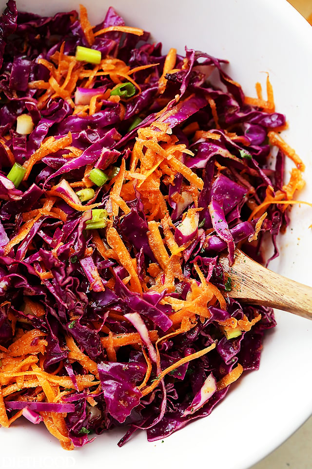 Red Cabbage and Carrot Slaw tossed in a white bowl.