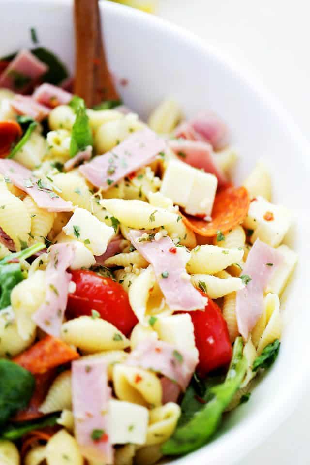 Close up of Italian pasta salad in a white bowl.