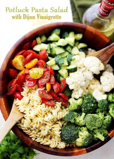 Potluck Pasta Salad with Dijon Vinaigrette - Quick and easy to make Potluck Pasta Salad packed with broccoli, tomatoes, cucumbers and cauliflower, all tossed in a zesty and delicious homemade Dijon Vinaigrette!