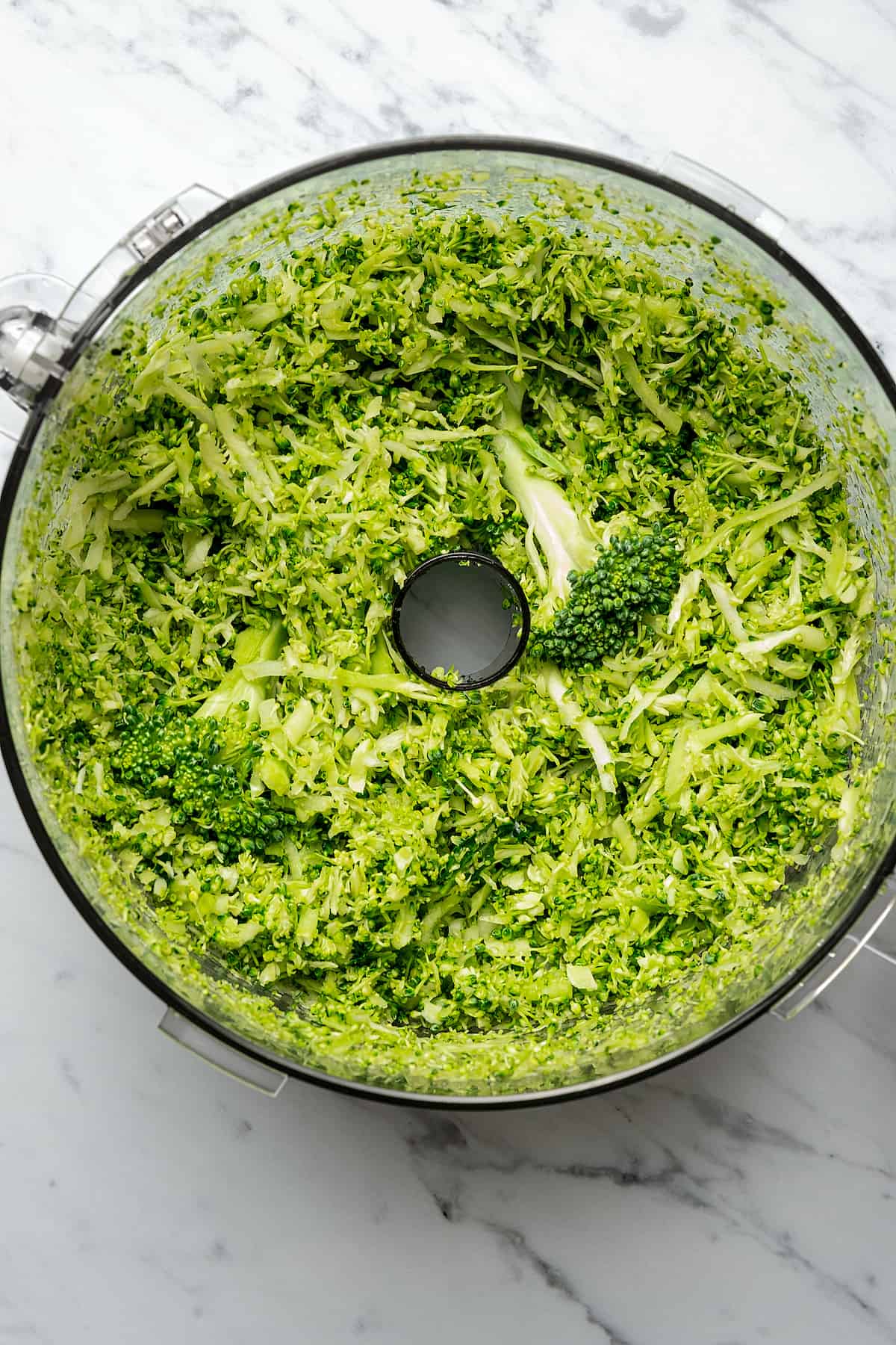 Shredded broccoli in a food processor.