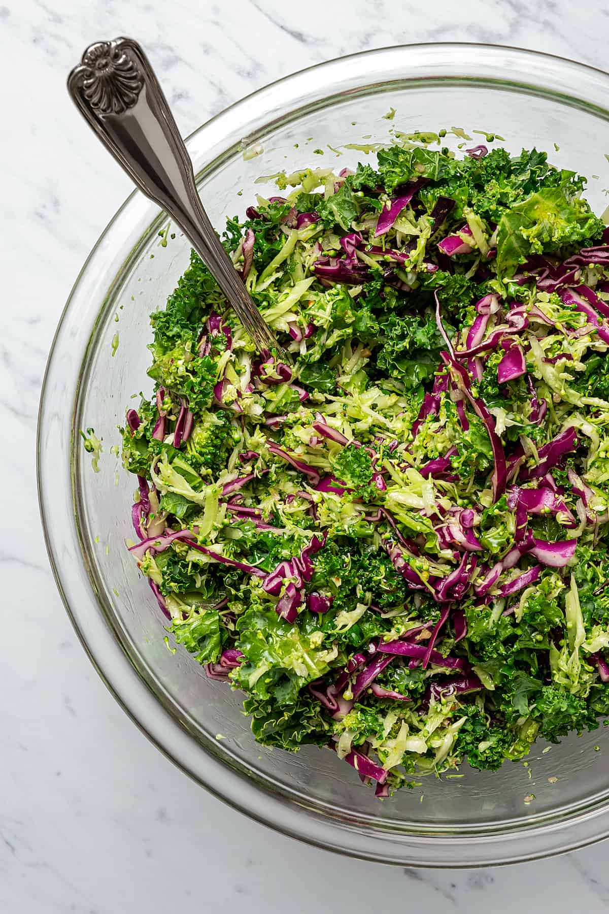 Homemade broccoli slaw in a mixing bowl.