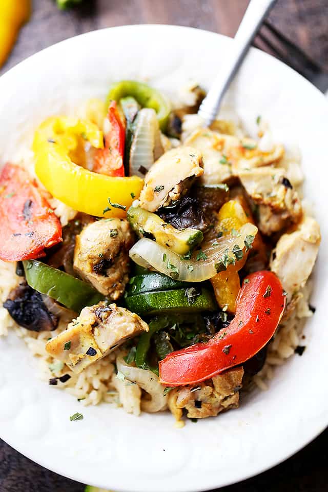 Overhead view of chicken ratatouille in a white bowl with a fork.