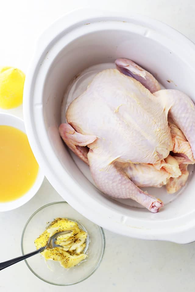 Crock Pot Honey Lemon Chicken Recipe - Rubbed with lemon-pepper butter and a sweet honey sauce, this is the easiest, most delicious whole chicken prepared in the crock pot! 