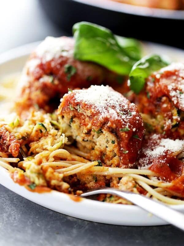 Ricotta Zucchini "Meatballs" - Delicious, melt-in-your-mouth-amazing zucchini meatballs with ricotta and parmesan cheese, topped with a warm and bubbly tomato sauce!